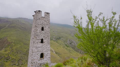 ancient stone tower in mountainous landscape