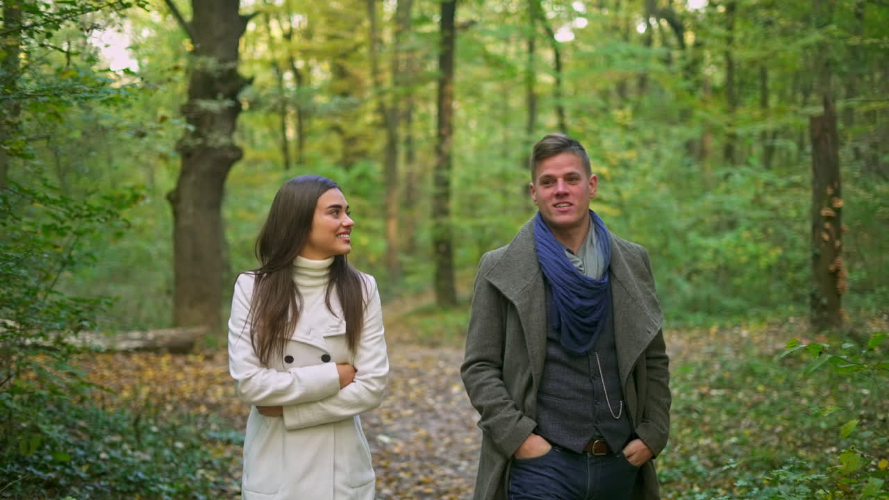 Couple walking in the forest during autumn