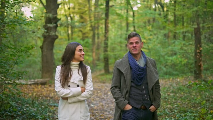 Couple walking in the forest during autumn