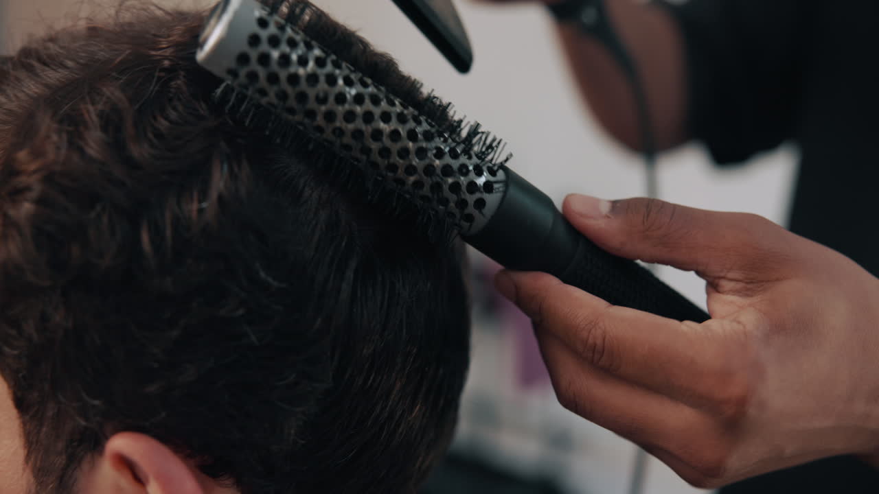 Close Up of Hair Stylist Blow Drying and Brushing Client's Hair