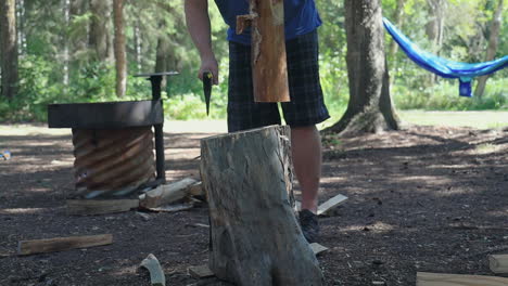 Man Chops Wood With An Axe At The Camping Site In Slow Motion