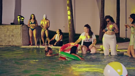 Friends enjoying a vibrant night pool party