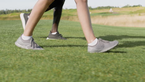 caucasian woman and african american man meeting on the golf course.