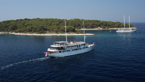 ferry boat with tourists cruising in the adriatic sea towards the paklinski islands in hvar, croatia