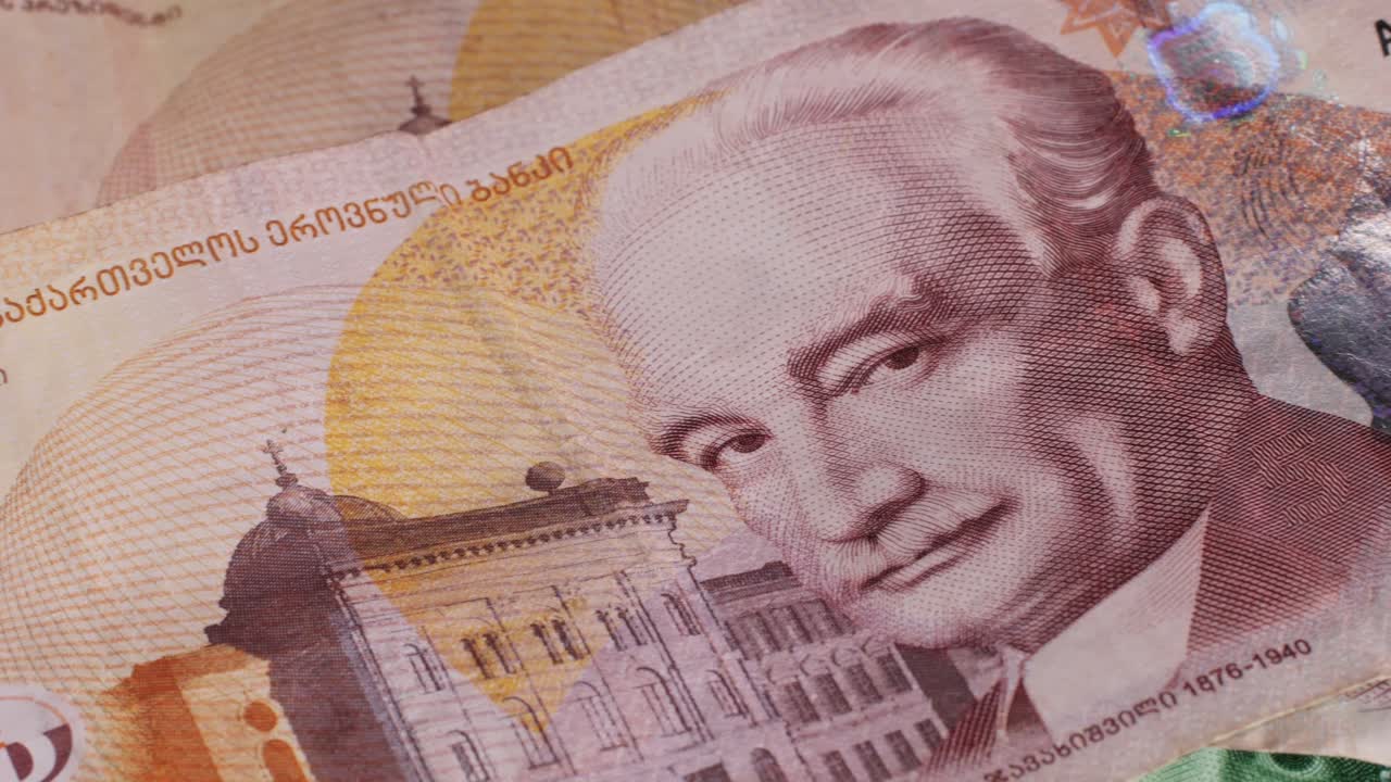 Five Georgian lari banknotes close-up. Universal currency converter GEL Central Bank. 5 lari paper money macro. Economy, financial and banking concept .