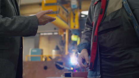 handshake of engineer and technician in factory