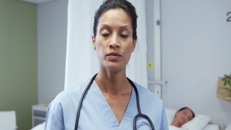 Front view of African american female doctor using digital tablet in ward at hospital 4k