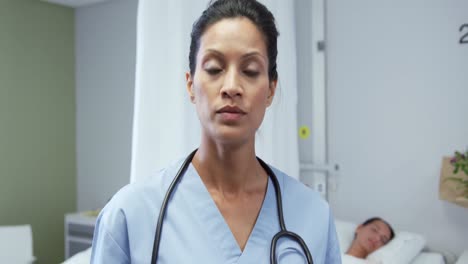 Front-view-of-African-american-female-doctor-using-digital-tablet-in-ward-at-hospital-4k