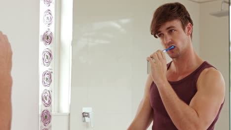 handsome man brush his teeth