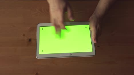 top view: man hands with a tablet pc with green screen