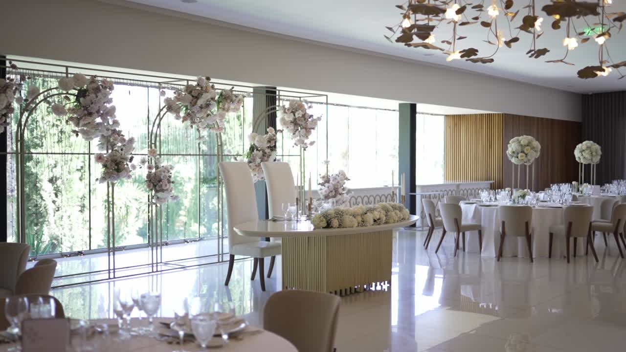 꽃 장식, 둥근 테이블, 밝은 자연 빛 을 가진 넓은 결혼식 리셉션