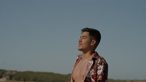 young man posing on sunny day