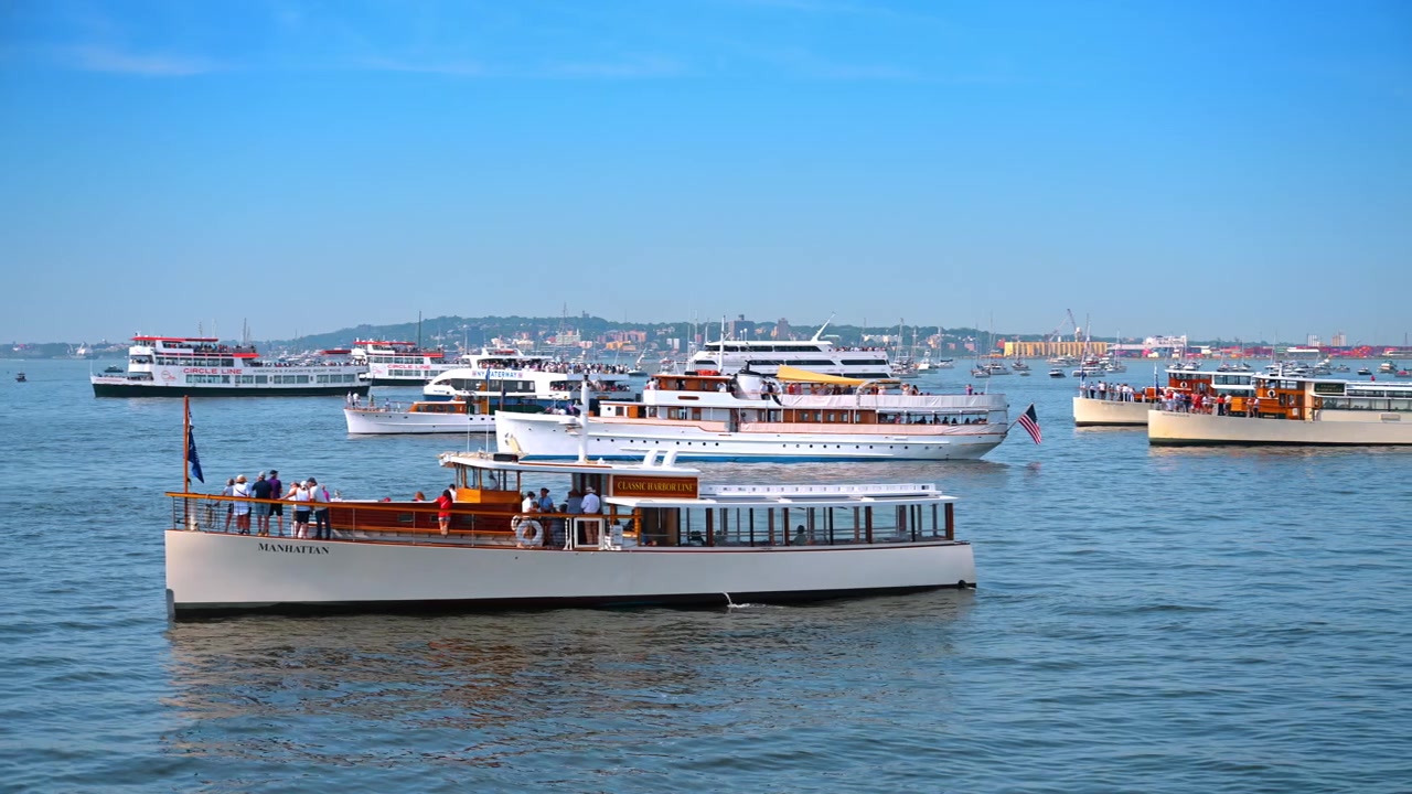 New York, USA, 4 Jule 2026 : Classic wooden motor yacht Manhattan on the water. Passengers stand on the deck of a vintage boat surrounded by other vessels in the harbor.