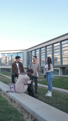 Vertical video of some students in a circle talking outside the university