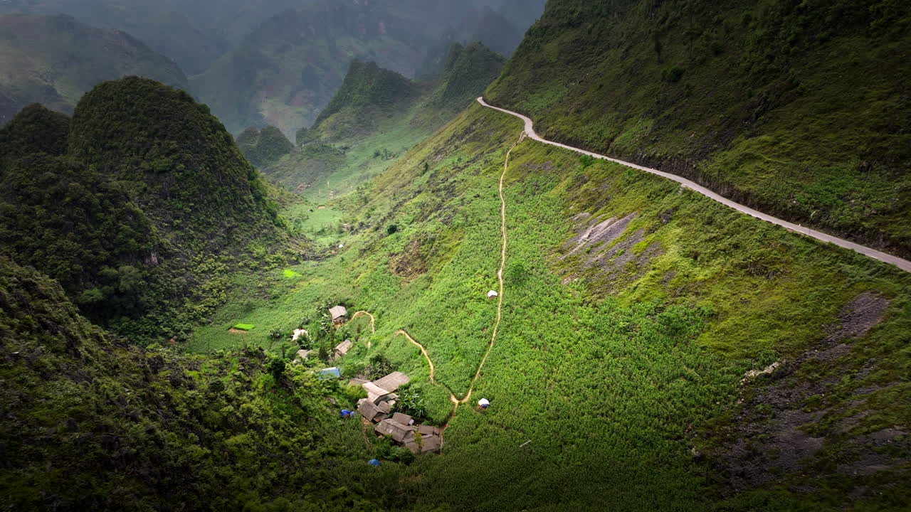 Traditional Homes In Lush Valley, Ha Giang Loop, Vietnam - Aerial Drone Shot