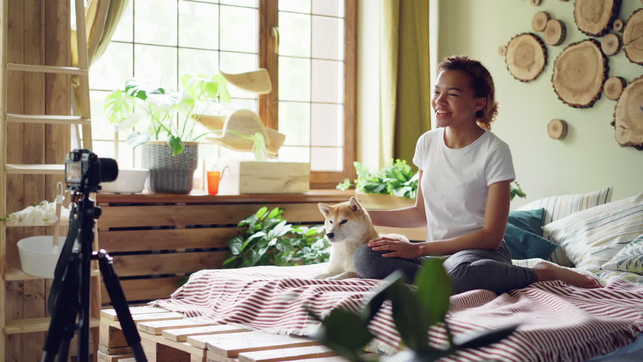 Young Woman Vlogging with her Dog in her Cozy Bedroom