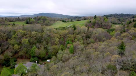 spring time rolling hills with mountains in background