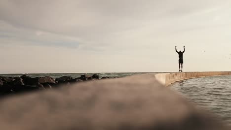 man jumping on the promenade