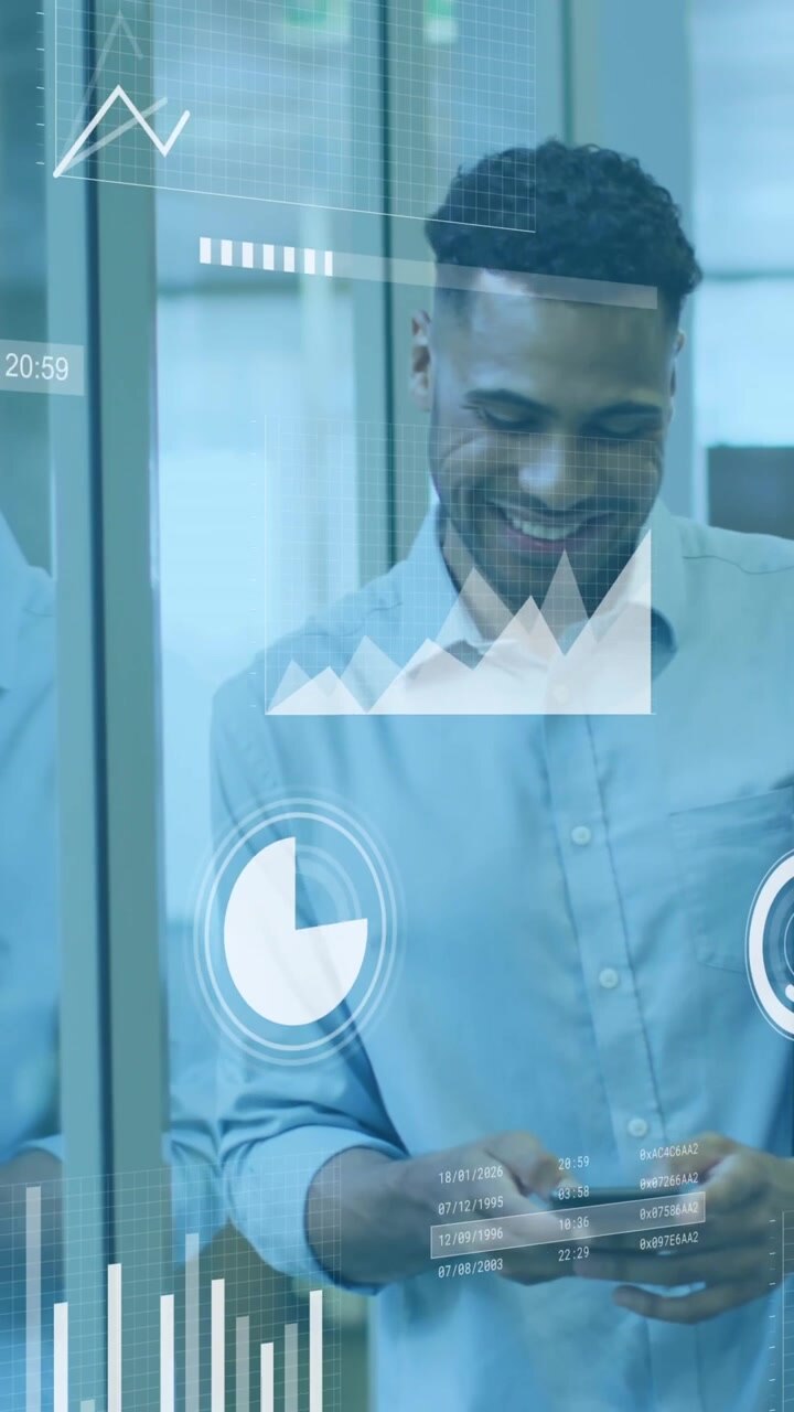 Animation of statistical data processing against man using smartphone smiling at office