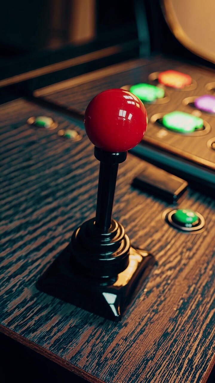 Close-up of a Red Arcade Joystick on a Retro Gaming Cabinet