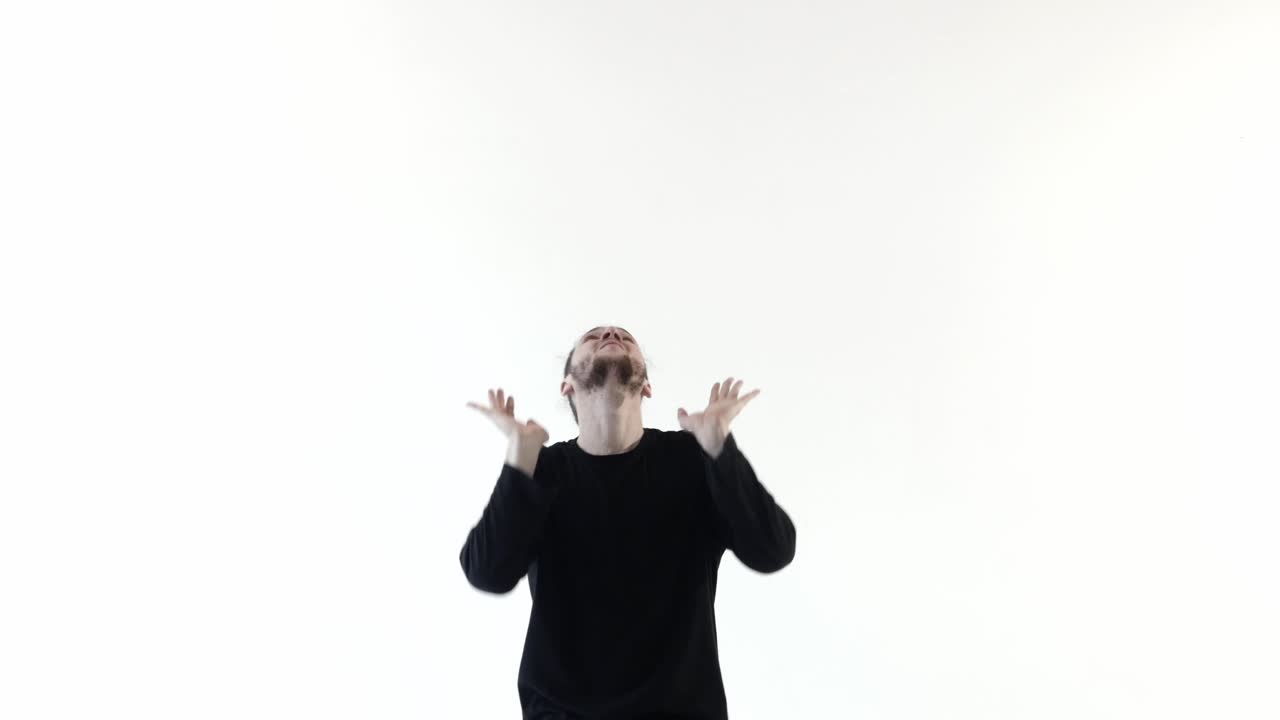 Young Man Dancing Expressively on a White Studio Background