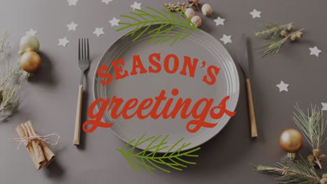 Animation-of-christmas-greetings-text-over-christmas-place-setting