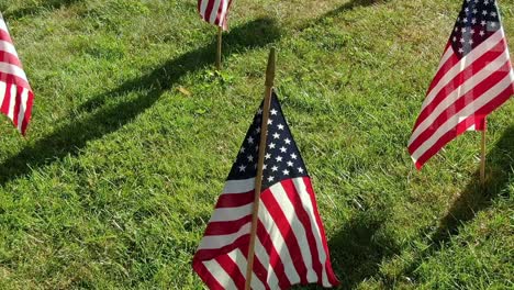 close up of american flags slowly fluttering in the wind on 4th of july