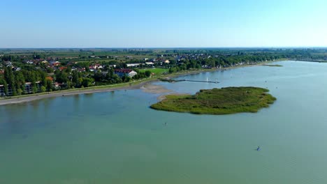 muelle de madera y ciudad costera en la orilla del lago neusiedl en austria