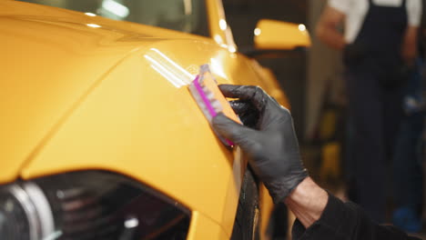 car detailing - polishing a yellow sports car