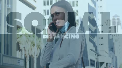 Animation-of-social-distancing-text-over-woman-using-smartphone-wearing-face-mask
