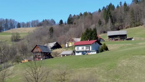 aerial approaching traditional slovenian house on a hill, bed and breakfast concept