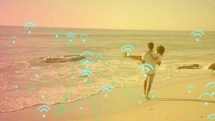 Mand løfter kvinde på sand, bærer, går for romantik, mens turkis Wi-Fi-teknologi skifter over parret.