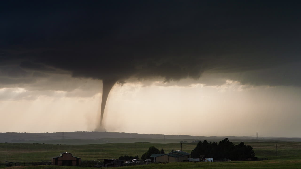Rotating Supercell Producing Powerful Tornado Over Rural Landscape