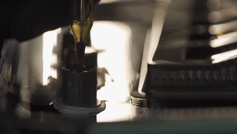 macro shot of tattoo machine put needle in container ink, shot in slow motion 120fps