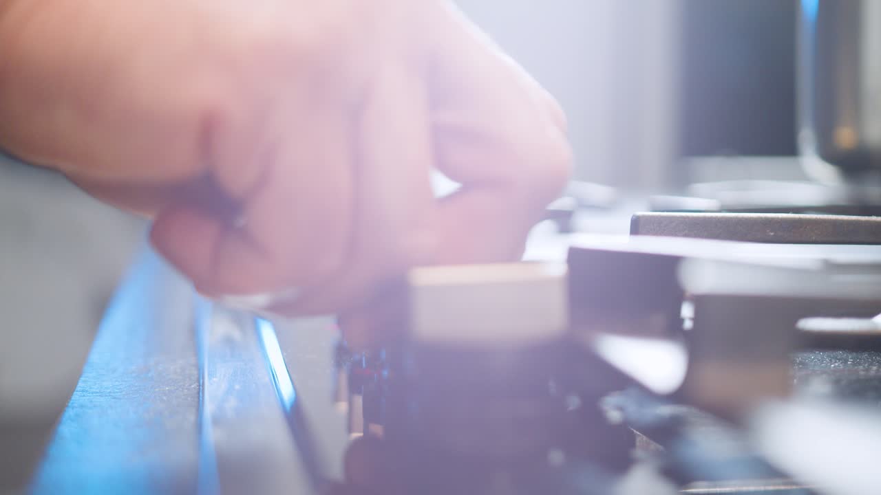 Hand of man ignites flame of stovetop. Slow-motion and close up
