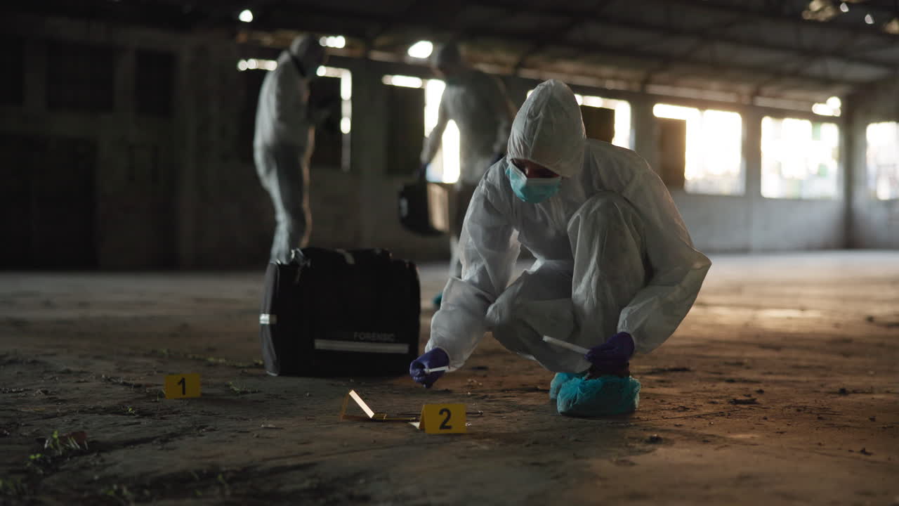 Forensic scientists collect evidence at a crime scene