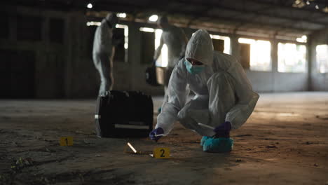 forensic scientists collect evidence at a crime scene