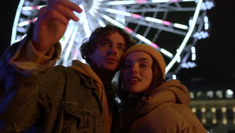 Lovely-couple-enjoying-romantic-night.-Man-speaking-with-girlfriend-on-street.