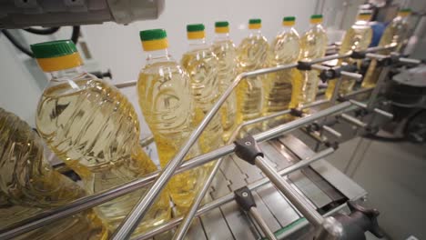 sunflower oil in the bottle moving on production line. bottling line of sunflower oil in bottles. vegetable oil production plant. high technology. industrial background