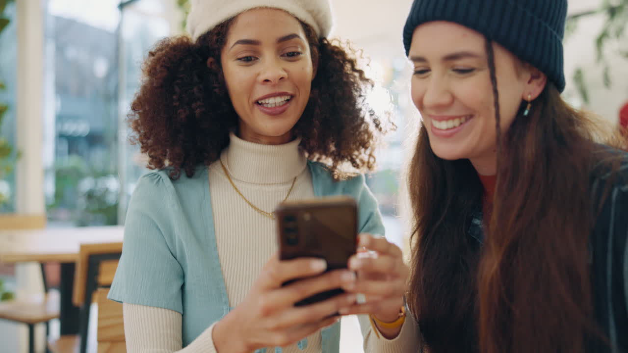 Two friends looking at a phone