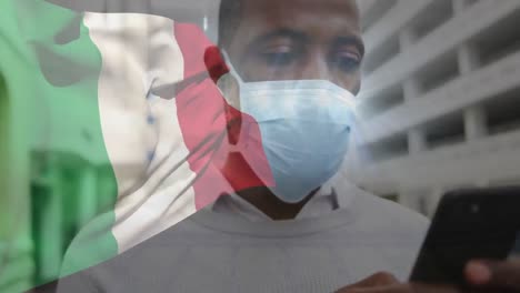 Animation-of-flag-of-italy-over-african-american-man-with-face-mask