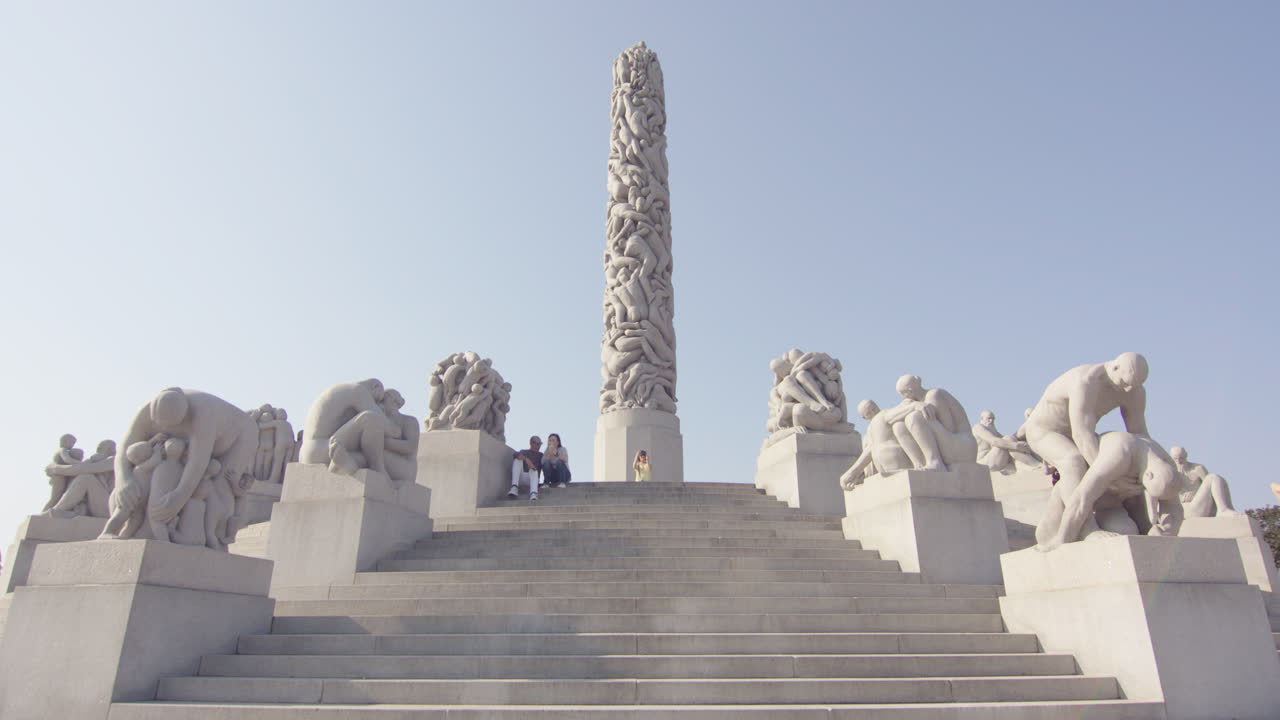 Wide tilt up to The Monolith in Vigeland Park, Oslo