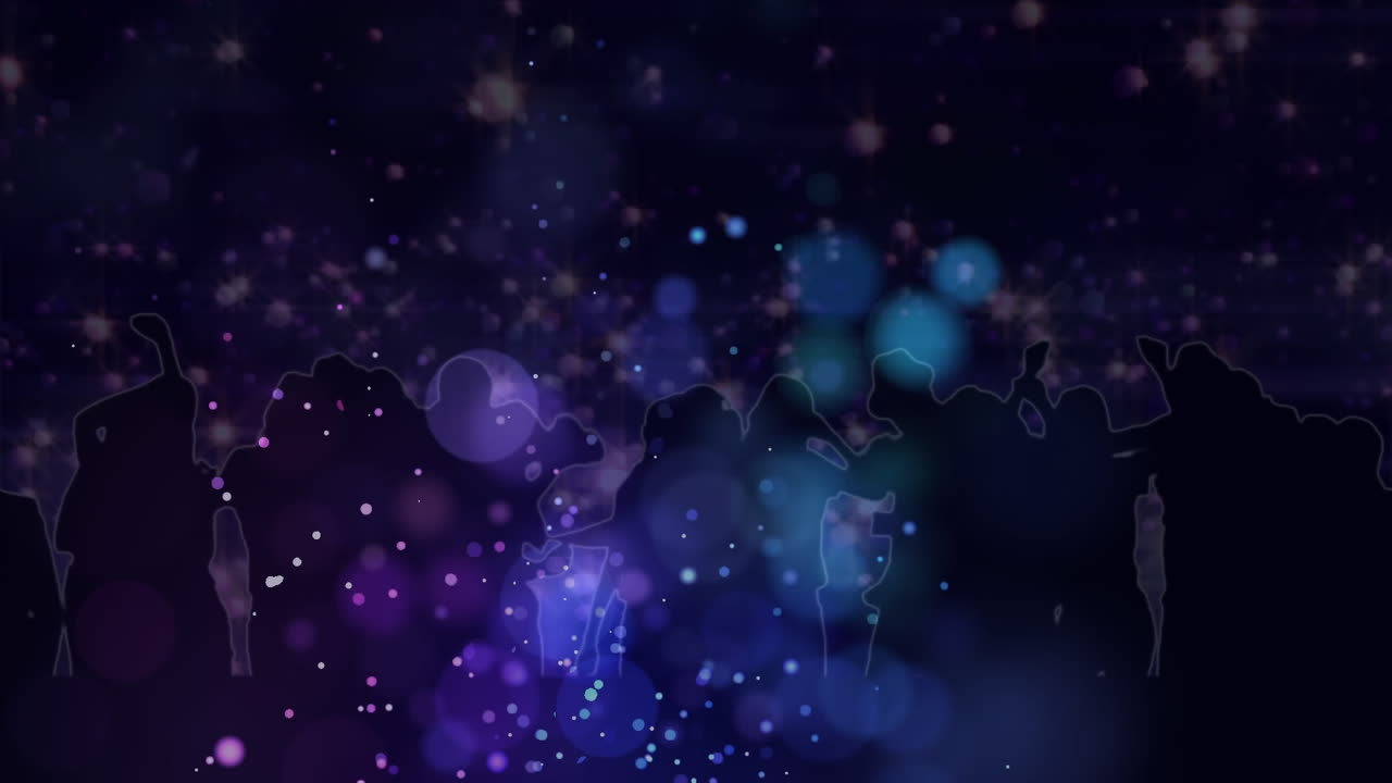 Purple spots of light against silhouettes of people dancing on black background