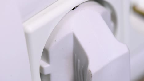 extreme close-up of plugging and unplugging from the european power socket