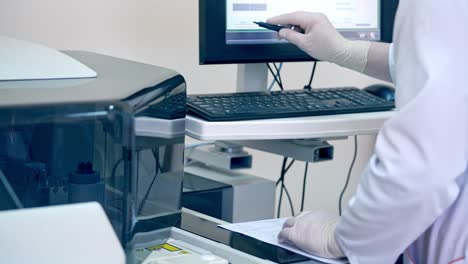 Modern laboratory for blood test. Close up view of doctor working in the research laboratory