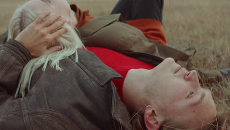 romantic couple lying on autumn field