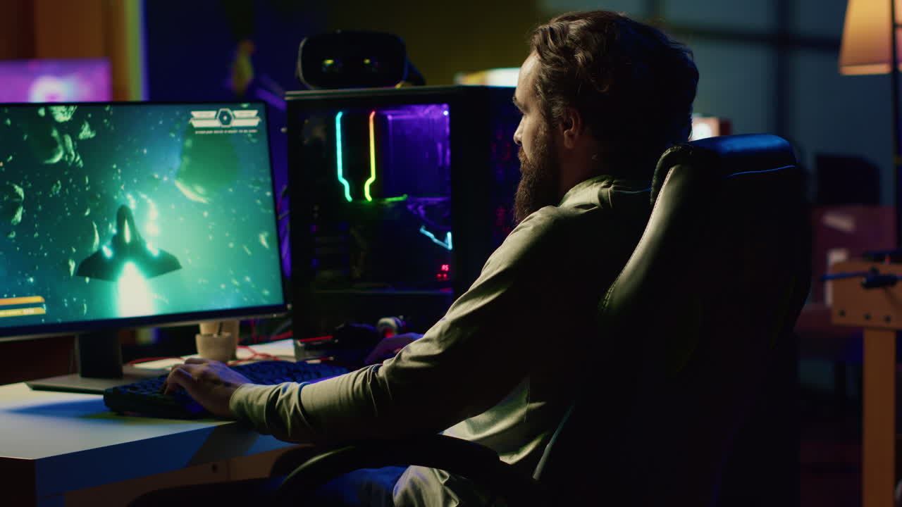 Happy man having fun by using gaming keyboard to fly spaceship in SF videogame