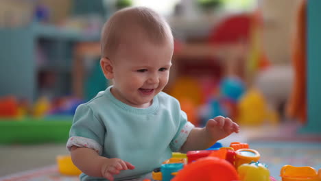 happy baby playing with colorful toys