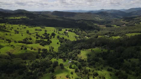 australian hinterland scene with sweeping valley pastures and stunning distant mountain views