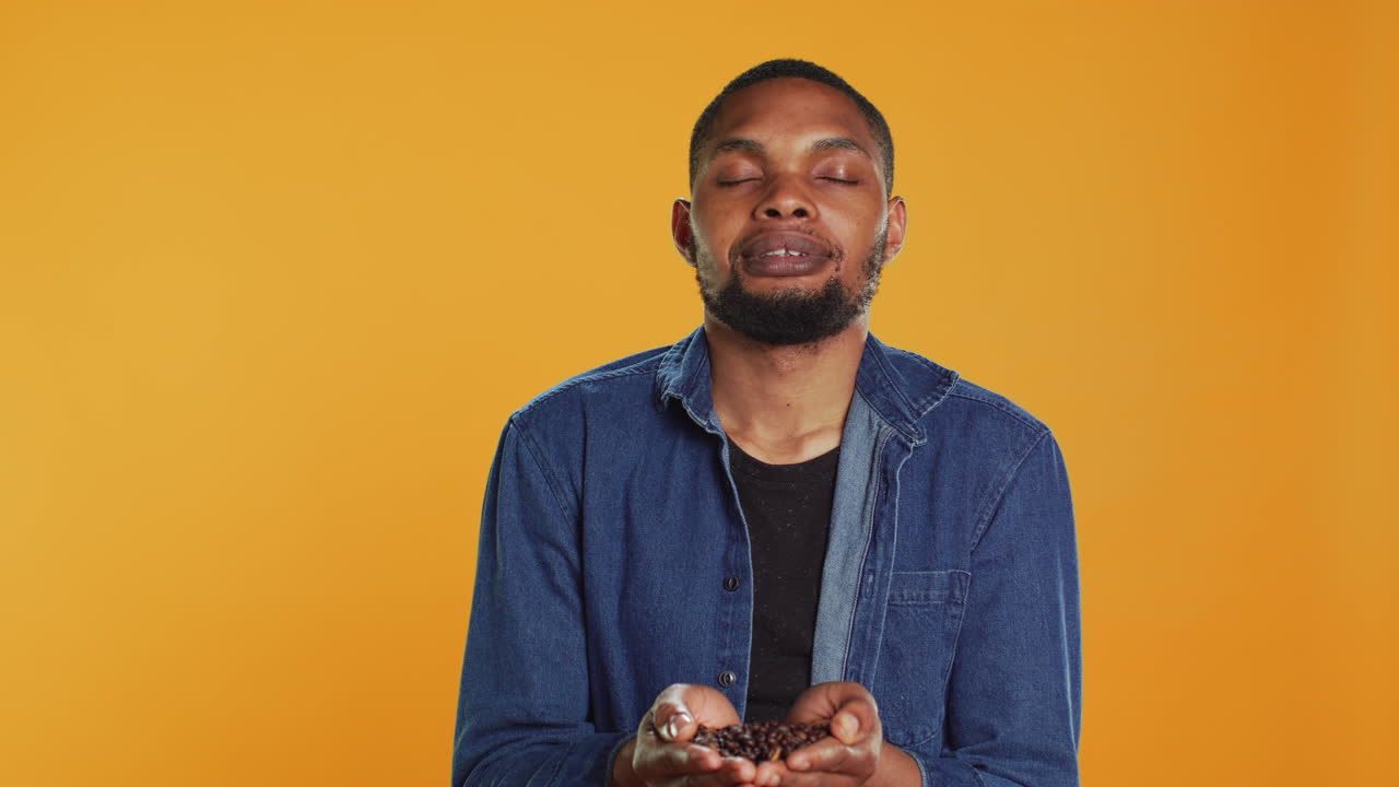 Coffee lover savoring the fresh natural black roast aroma in studio